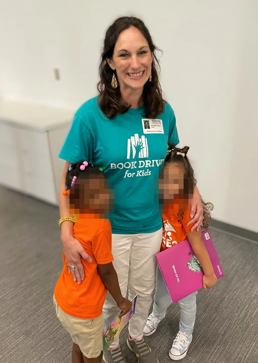 Brooke Terry with two students at a Book Drive for Kids book fair