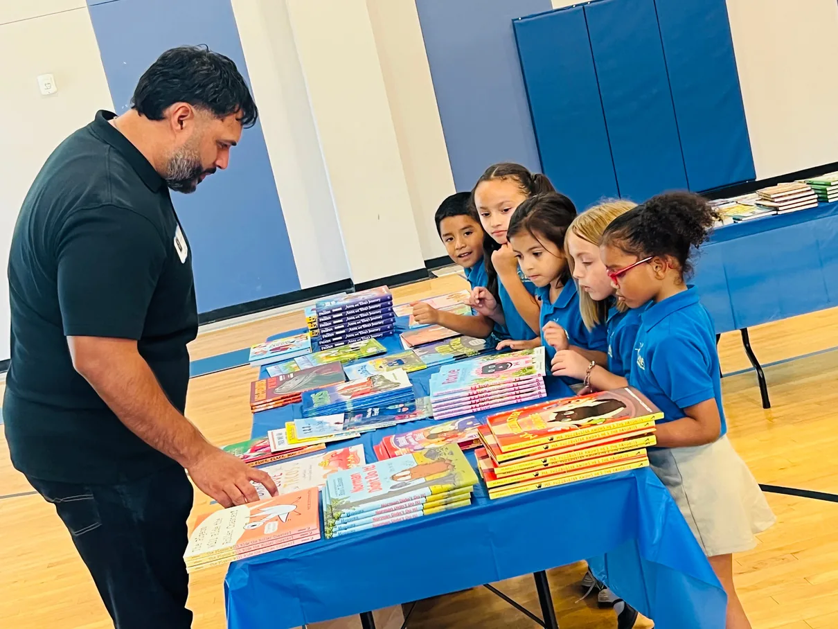 Students looking at book choices at IDEA Parmer Park.