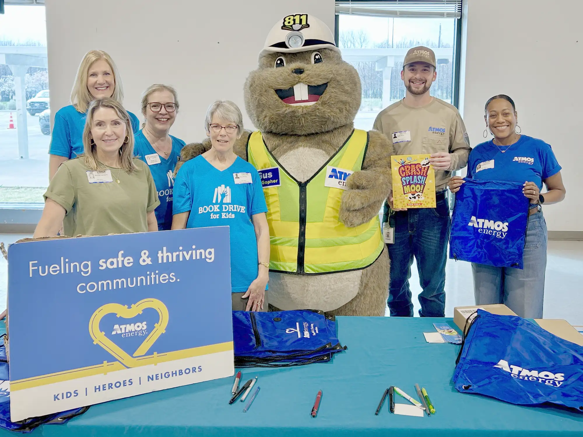 Atmos Energy and Book Drive for Kids volunteers with Gus the Gopher at a book fair