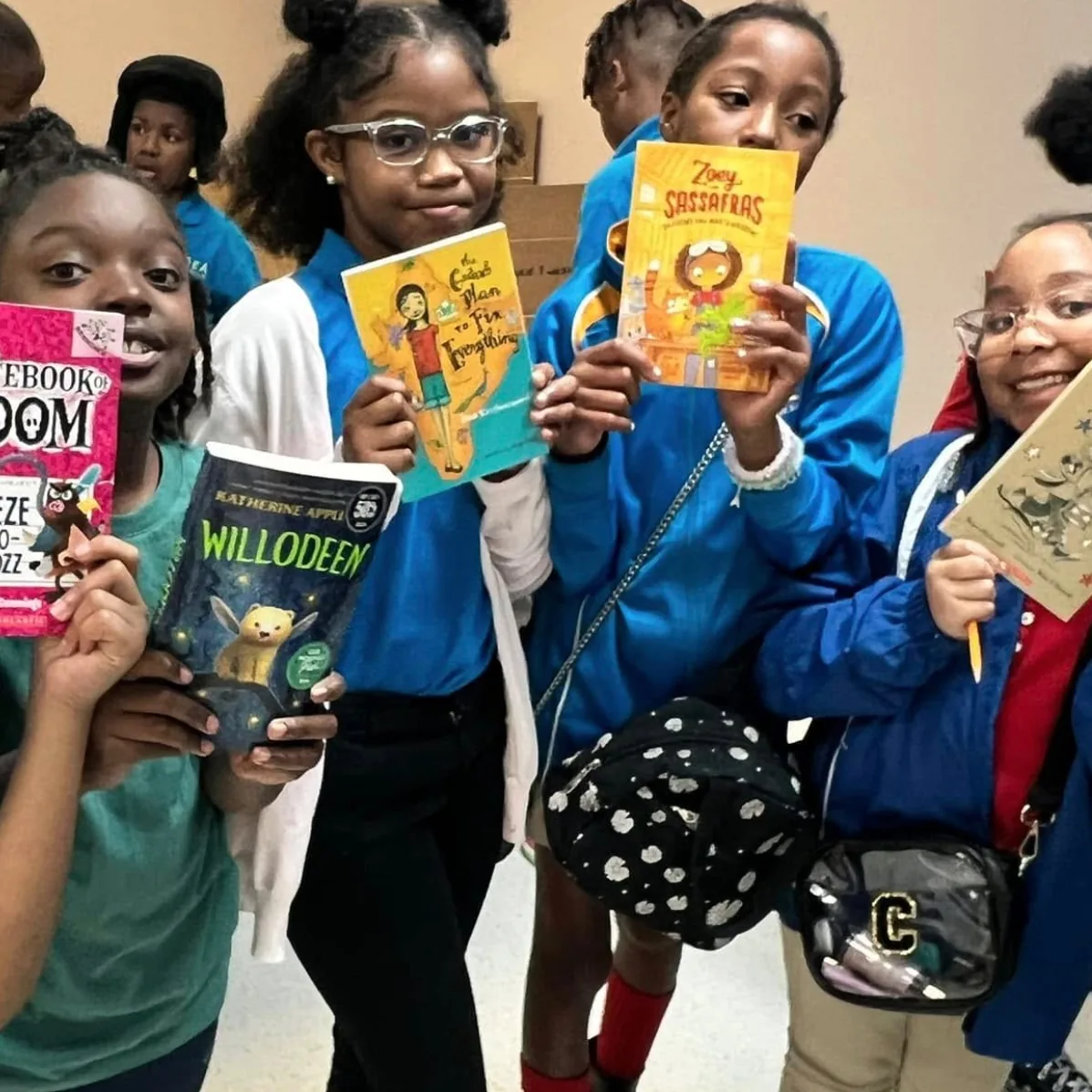 Students at IDEA A.W. Brown show off the brand-new books they chose
