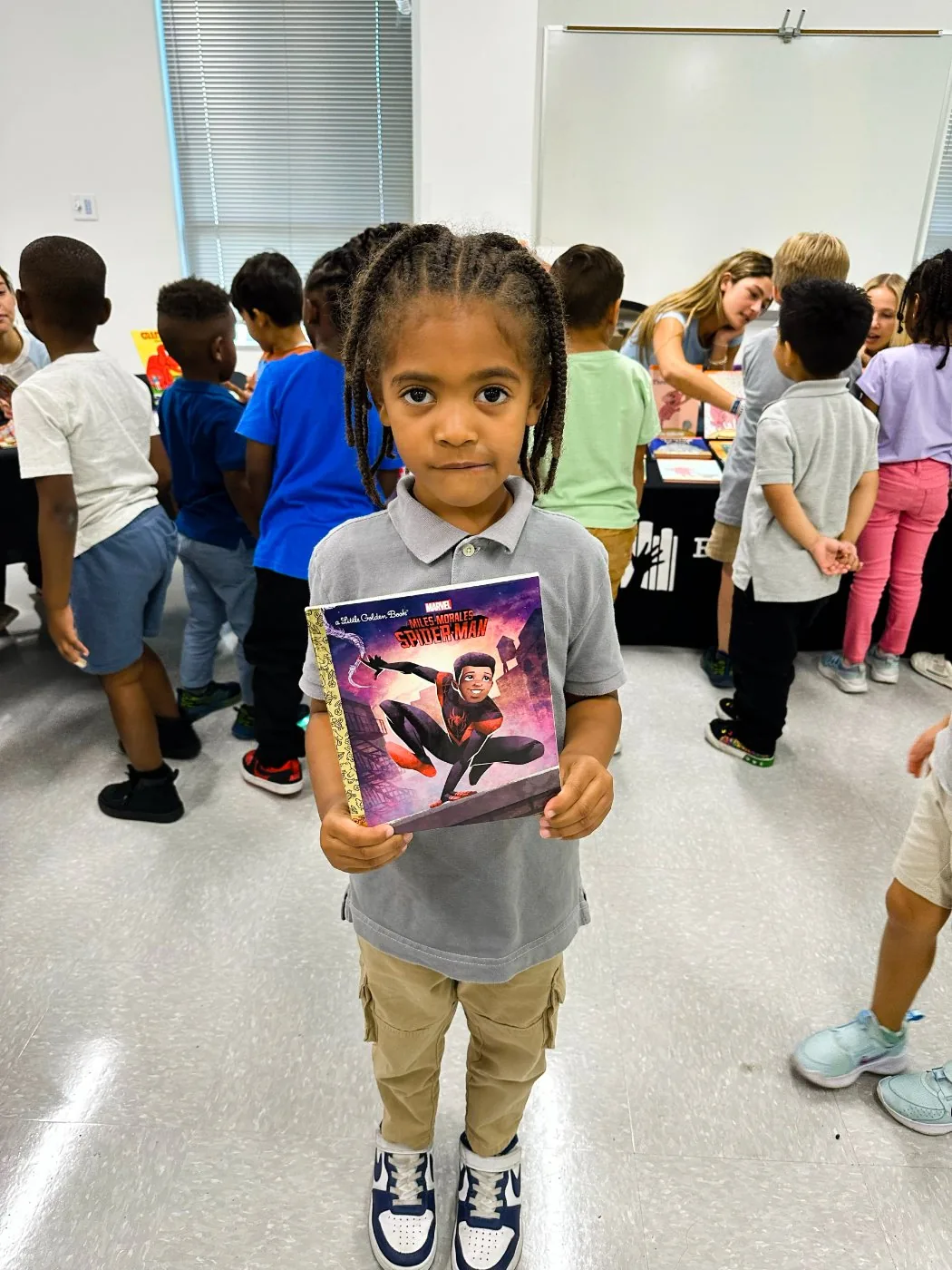 A student at Austin Achieve Pflugerville with their book.